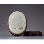 A pale jade ink stone in a wooden box