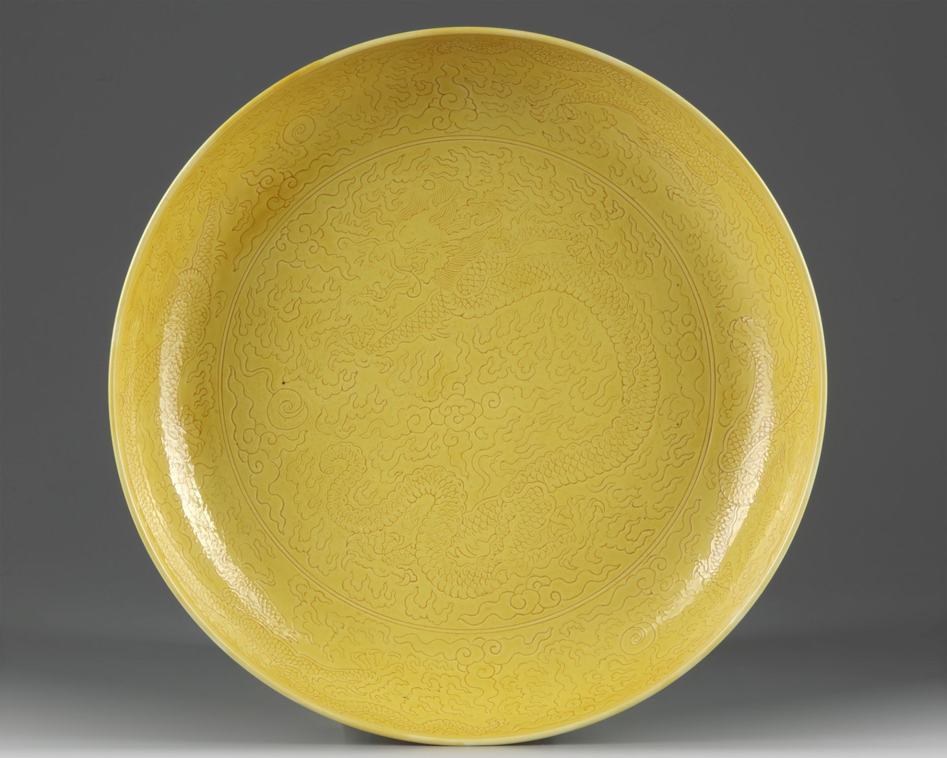 A Chinese yellow-glazed 'dragon' charger