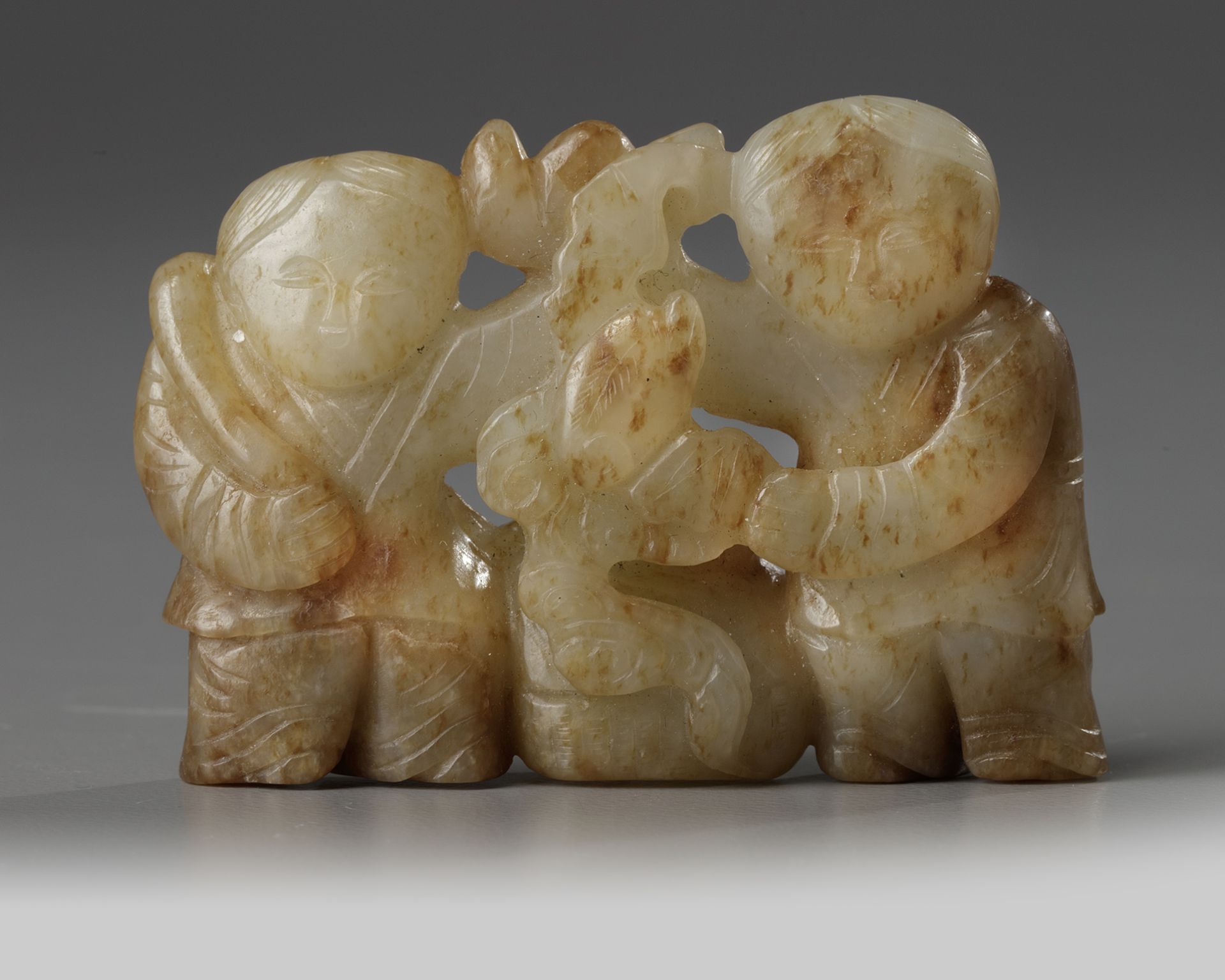 A Chinese celadon and russet jade 'Hehe Erxian' carving