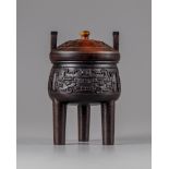 A Chinese hardwood archaistic tripod censer and cover