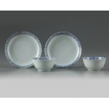 A pair of Chinese bianco sopra bianco-decorated cups and saucers