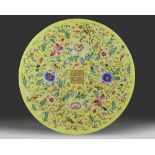 A massive Chinese yellow-ground famille rose circular plaque