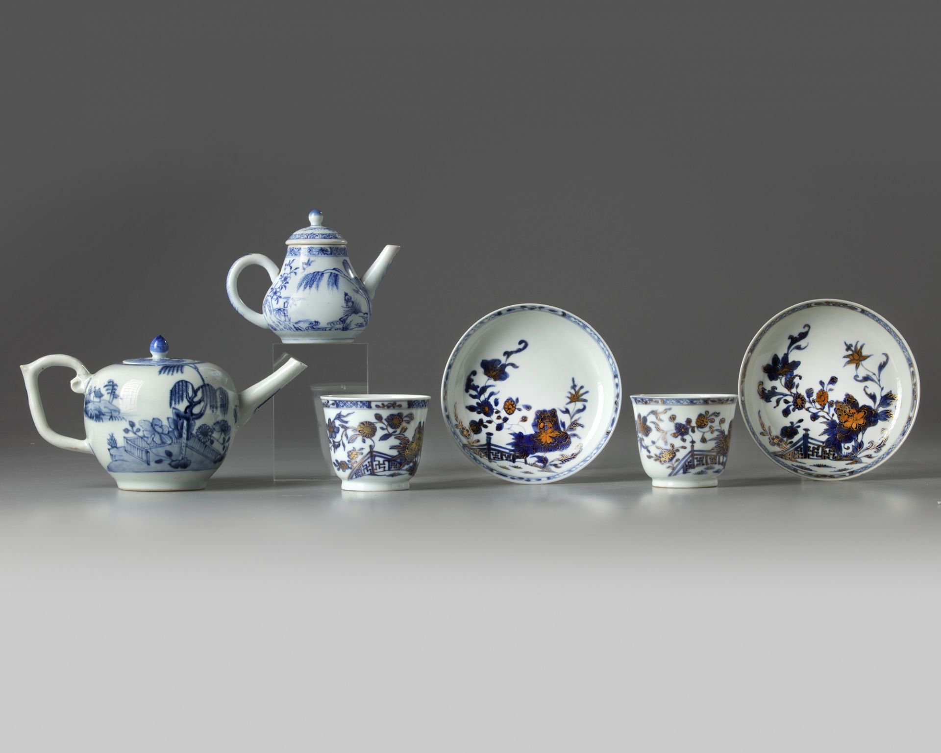 A group of Chinese blue and white teapots, cups, and saucers