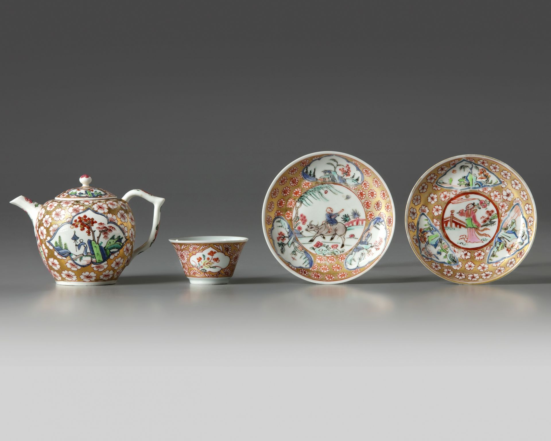 A Chinese gilt and famille rose-decorated cups and saucers and a Meissen 'Chinoiserie' teapot