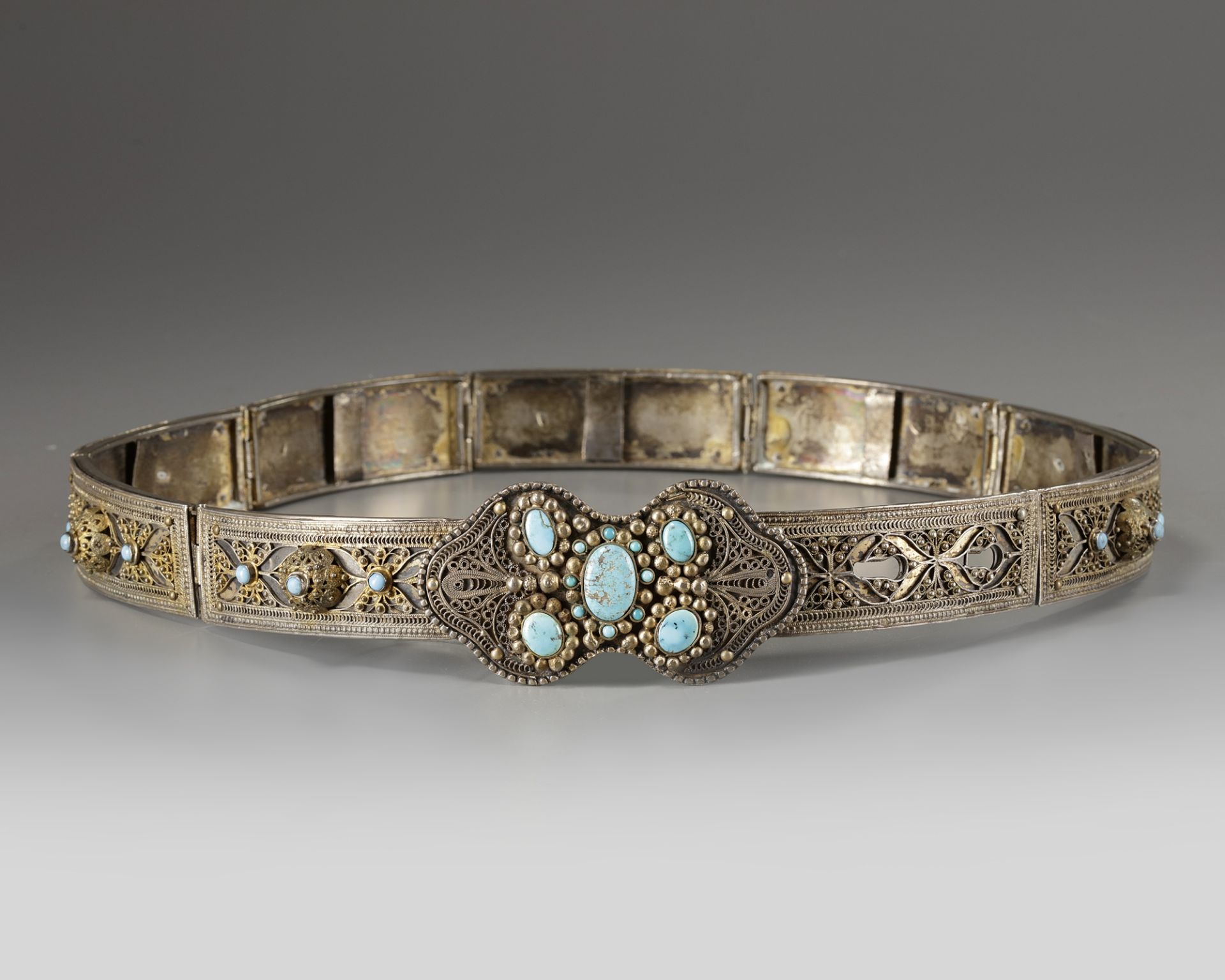 A silver and turqouise inlaid belt