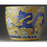 A large Chinese yellow-ground blue and white ‘dragons’ jardinière