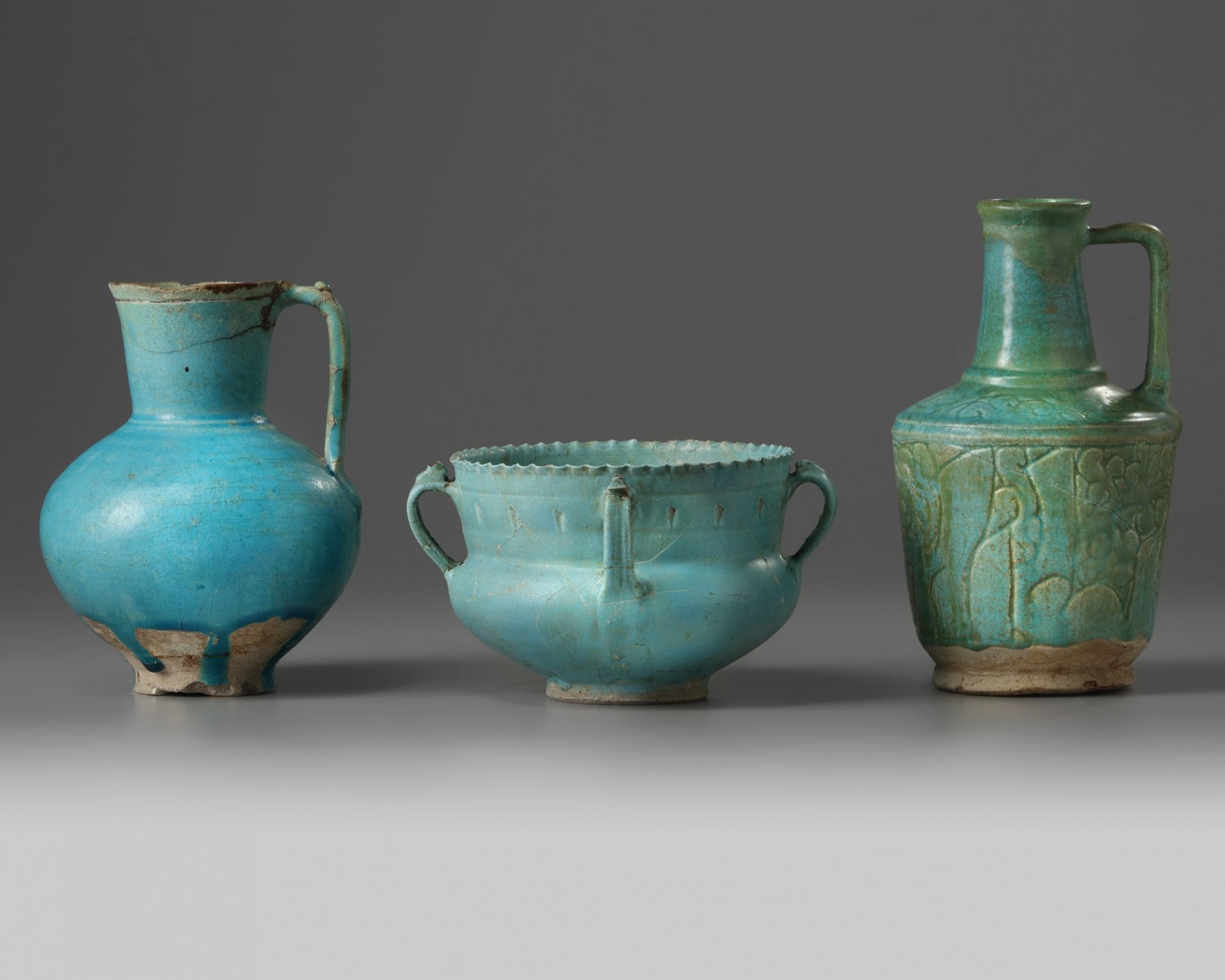 Two Islamic turquoise glazed jugs and a bowl