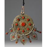 An Islamic gilt and silver inlaid pendant