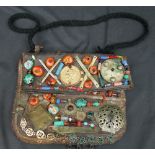 Leather antique messenger bag with later added decoration in the form of trade beads and pieces of