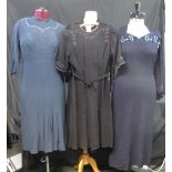 Four vintage 1940's dresses to include: a black knee length crepe belted dress with floral