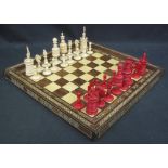 EARLY 20TH CENTURY INDIAN CARVED AND STAINED BONE CHESS SET, together with associated hardwood,