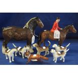 Beswick china huntsman on bay hunter together with a group of five hounds,