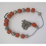 An amber and white metal worry beads, the string L66cm.