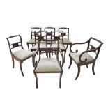 A set of six Regency style mahogany dining room chairs and two armchairs. The backs with brass