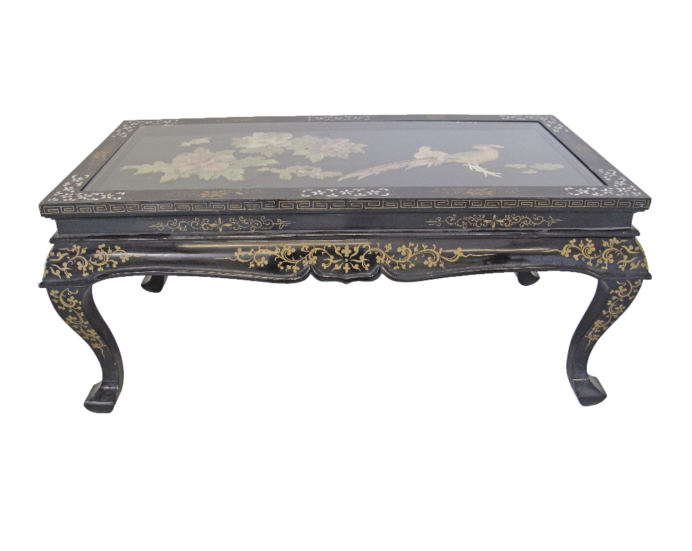 A Chinese black lacquer, painted and mother of pearl inlaid coffee table with collapsible legs.