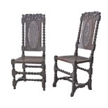 A pair of Jacobean, English 17th century style carved walnut high back side chairs, with spiral