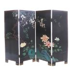 A Chinese four fold screen, black lacquer ground, carved decorations on both sides, flowers and