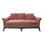 An English Chippendale style carved mahogany frame three seater sofa in red floral upholstery.