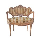 A French Louis XV - Rococo style carved and parcel giltwood marquise en corbeille, with traces of