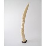 An African carved ivory tusk of a native figure of a man. L56cm, weight 1173g