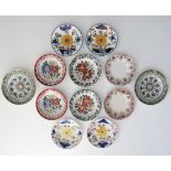 A collection of twelve antique Folk Art ceramic plates comprising six pairs of floral hand decorated