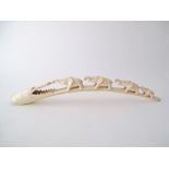 An African carved ivory tusk with four elephants and a crocodile head. L66cm, weight 1100g