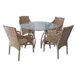 A set of four bamboo armchairs and a round glass top center table diam. 122cm, on black metal