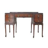 A carved mahogany kneehole dressing table / writing table, with parcel gilt carvings and brass