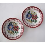 A pair of ceramic plates, D23cm, Folk Art hand painted with flower bouquets in the middle, red