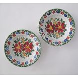 A pair of ceramic plates, D22.5cm, Folk Art hand painted with flower bouquets in the middle,