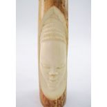 A carved African ivory tusk.