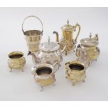 A collection of silver plated brassware comprising two tea pots, a coffee pot H20cm, one sugar bowl,