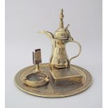 A collection of engraved brass artifacts comprising a round tray W36cm, a cigarette box, an ashtray,