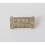 An Art Deco antique diamond filigree brooch consisting of silver topped 14 karat yellow gold,