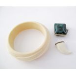 An African elephant ivory carved bangle W90mm together with a claw pendant and a malachite pendant