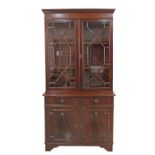 A Georgian style flame mahogany side cabinet with two doors over two drawers and independent two