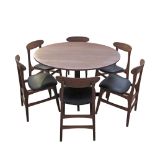 A vintage Danish Farstrup style dining suite comprising a round teak veneered table W120cm on