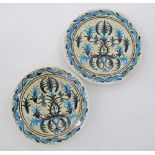 A pair of Greek Keramikos ceramic chargers hand decorated with blue and green foliage W33cm and