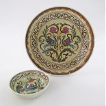A set of two ceramic Greek Keramikos dishes, hand decorated with birds and foliage, the charger