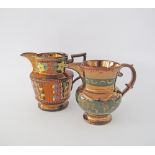 Two Staffordshire copper lustre jugs with flowers and green handmade leaf decorations, c19th