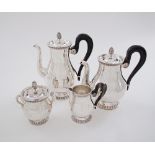 A vintage Christofle four piece tea-coffee set comprising a tea pot, coffee pot, lidded sugar bowl