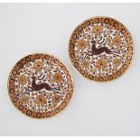 A pair of Greek Rhodian ceramic plates hand decorated with deer. Marked J BISCUS Rodos - Hellas,