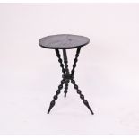 A provincial ebonized tripod wine table with turned supports. H67cm, W43cm.