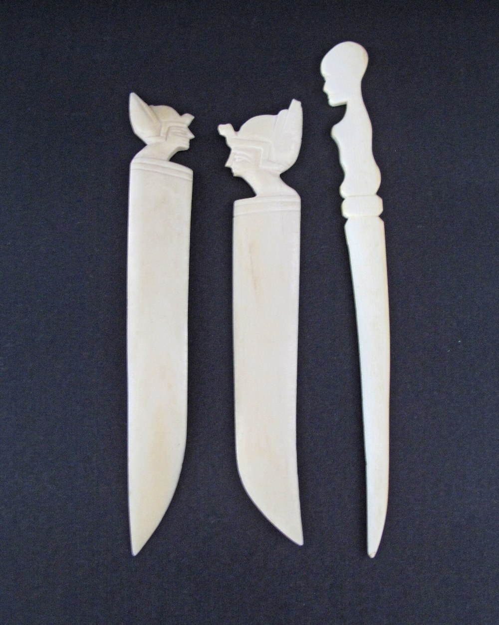 A collection of three African carved ivory paper knives, late 19th / early 20th century with