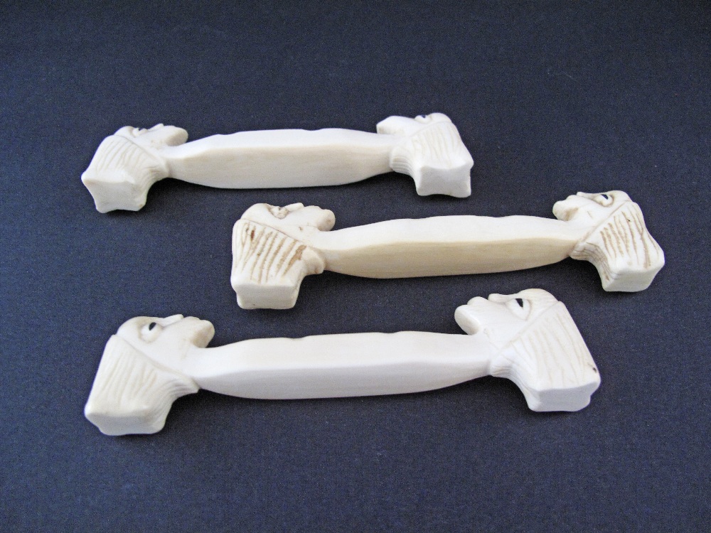 A set of three carved ivory knife rests with heads, probably African, c19th / early 20th century, - Image 2 of 3