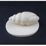 A carved ivory paper-weight with carved snail on plinth. Weight 111g, W80mm. This lot complies