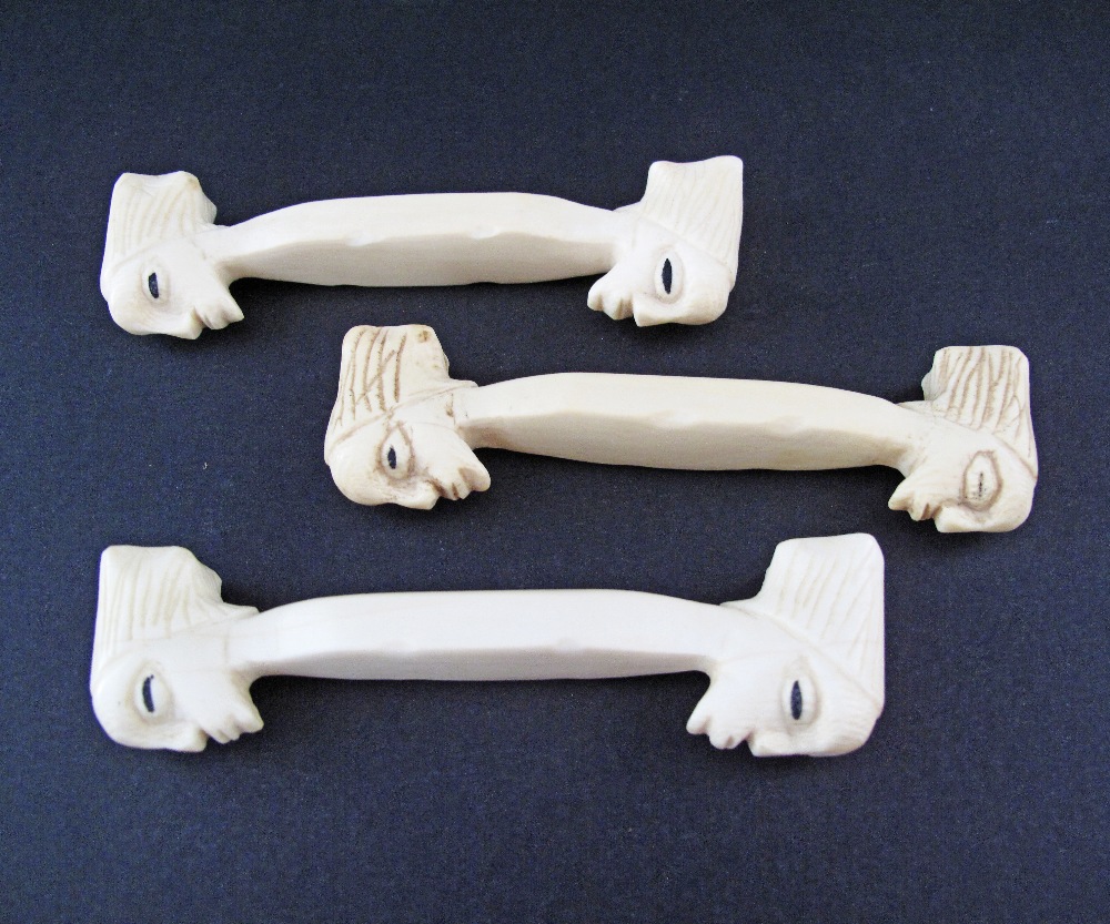 A set of three carved ivory knife rests with heads, probably African, c19th / early 20th century, - Image 3 of 3