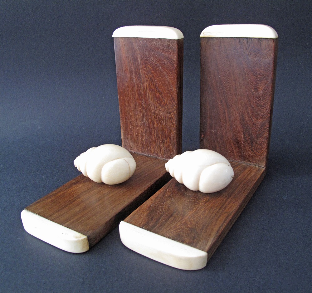 A pair of hardwood and ivory book-ends c19th century, each with a carved ivory snail. Weight incl.