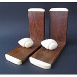 A pair of hardwood and ivory book-ends c19th century, each with a carved ivory snail. Weight incl.