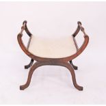 A Regency style mahogany Curule form x-frame stool with turned stretchers upholstered in beige,